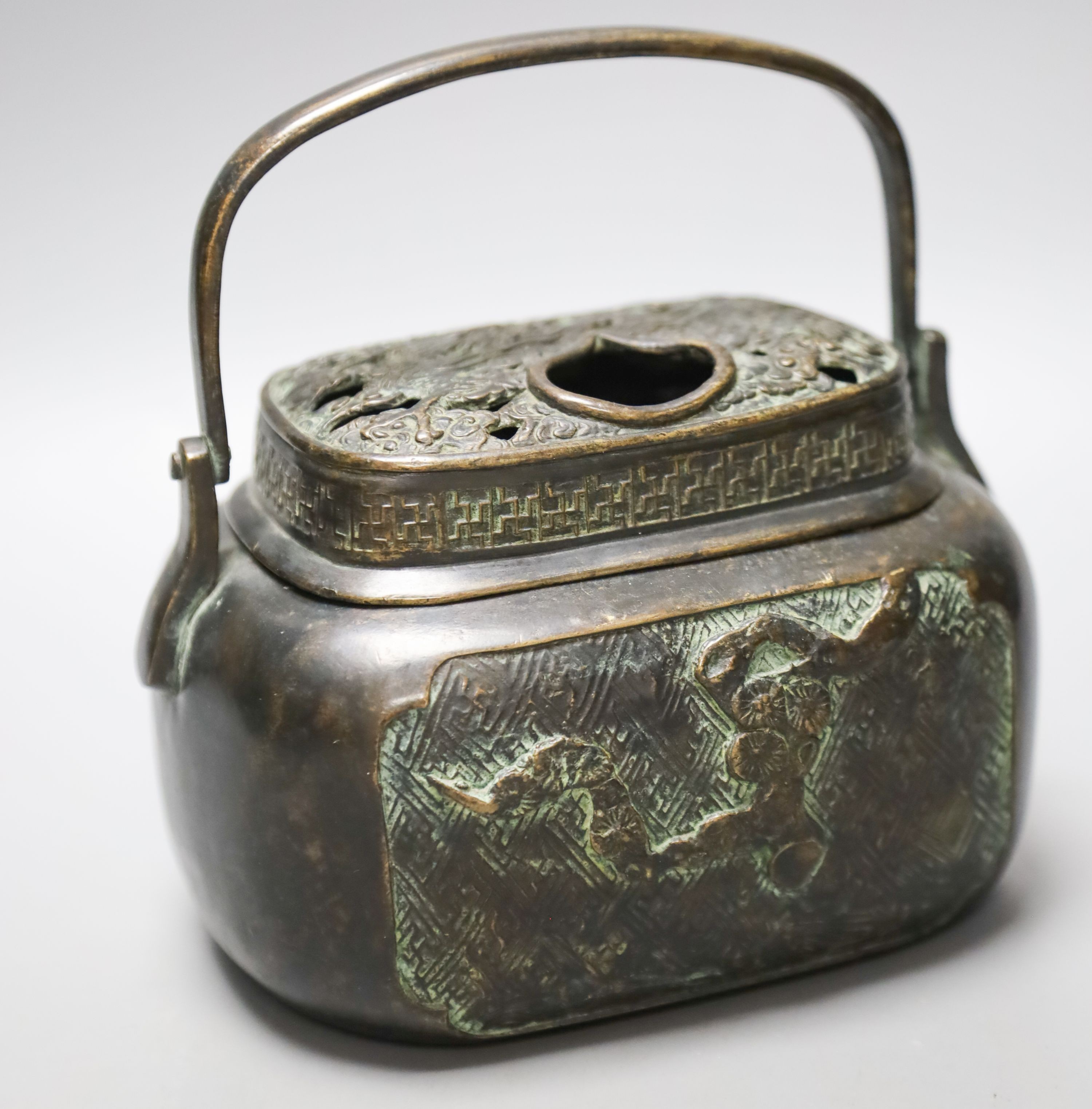 A Chinese bronze hand warmer, Xuande mark to base, old repairs 15cm